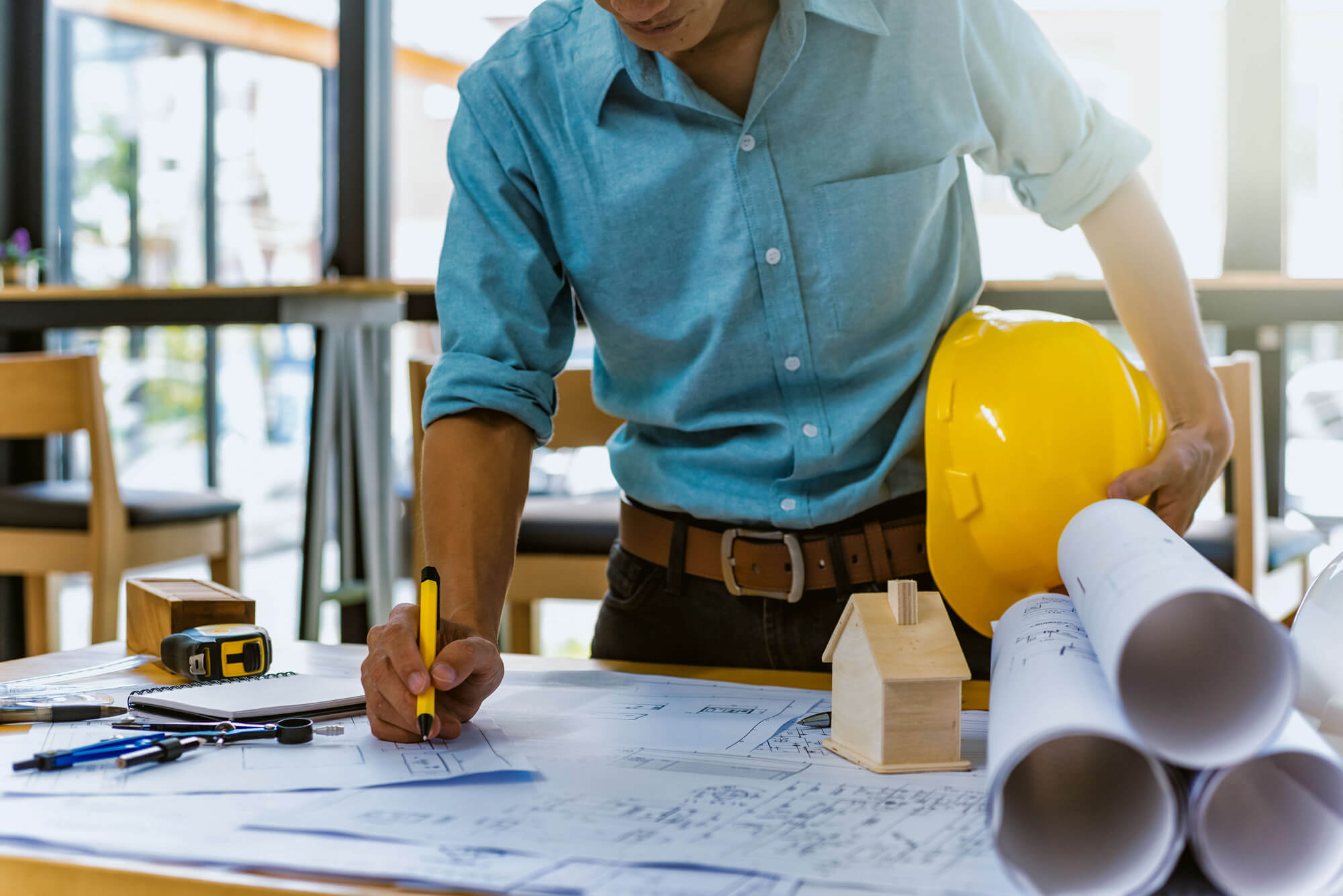 Man looking over blueprints.