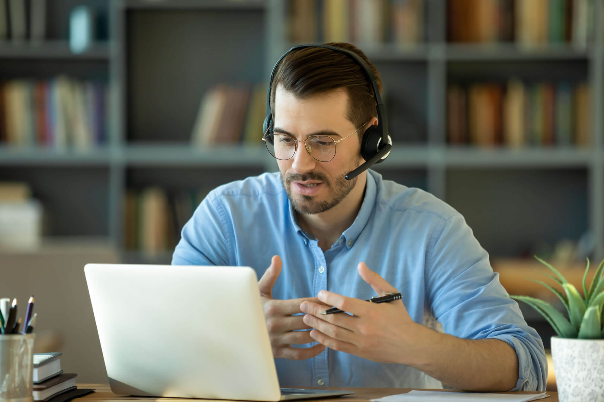 Man speaking on a headset.