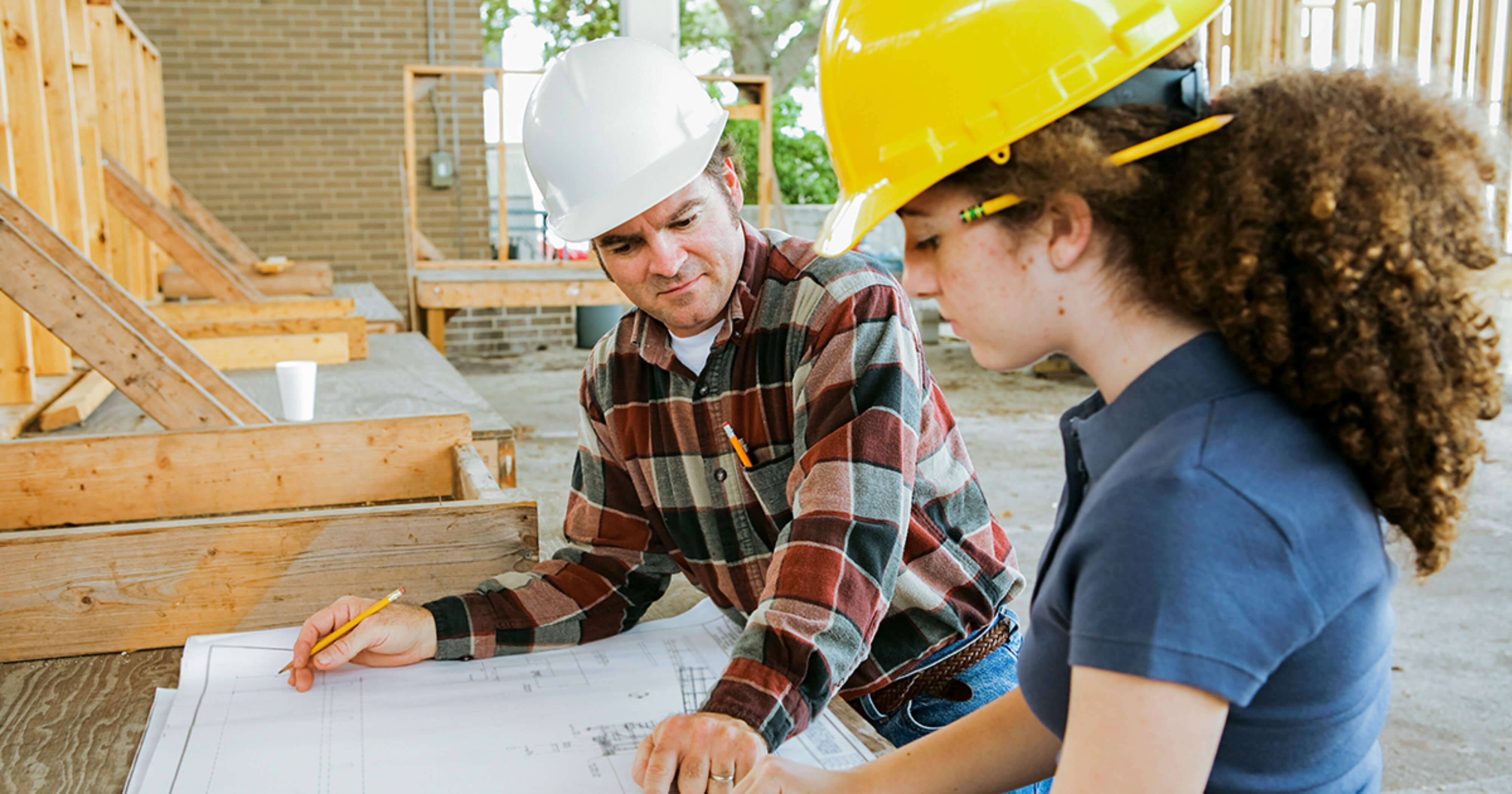 Apprentice mentor teaching construction student.